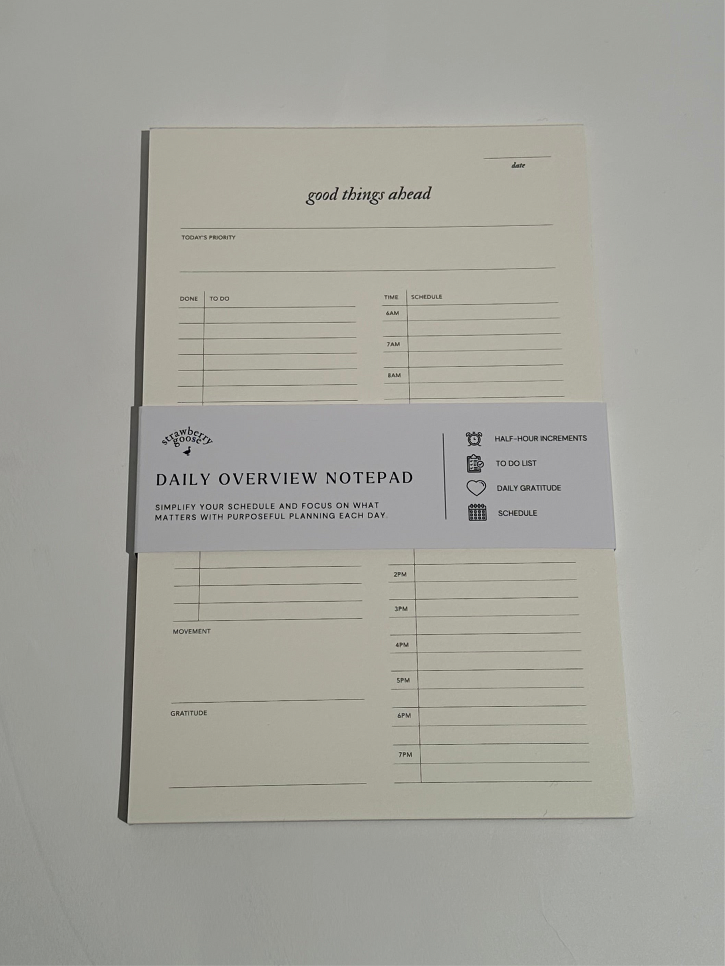 A Daily Notepad with 30-minute increments for scheduling, a to-do list for tasks, daily reflections, and a space to track daily movement and top priority.