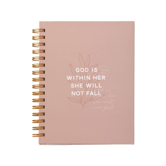 Pink notebook with gold spiral binding and motivational quote on a white background