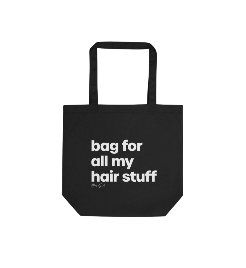 Black tote bag with text 'bag for all my hair stuff' on a clear background